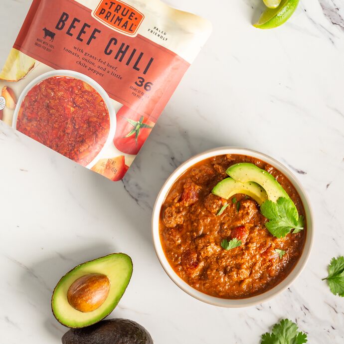 True Primal Beef Chili in bowl with avocado slices